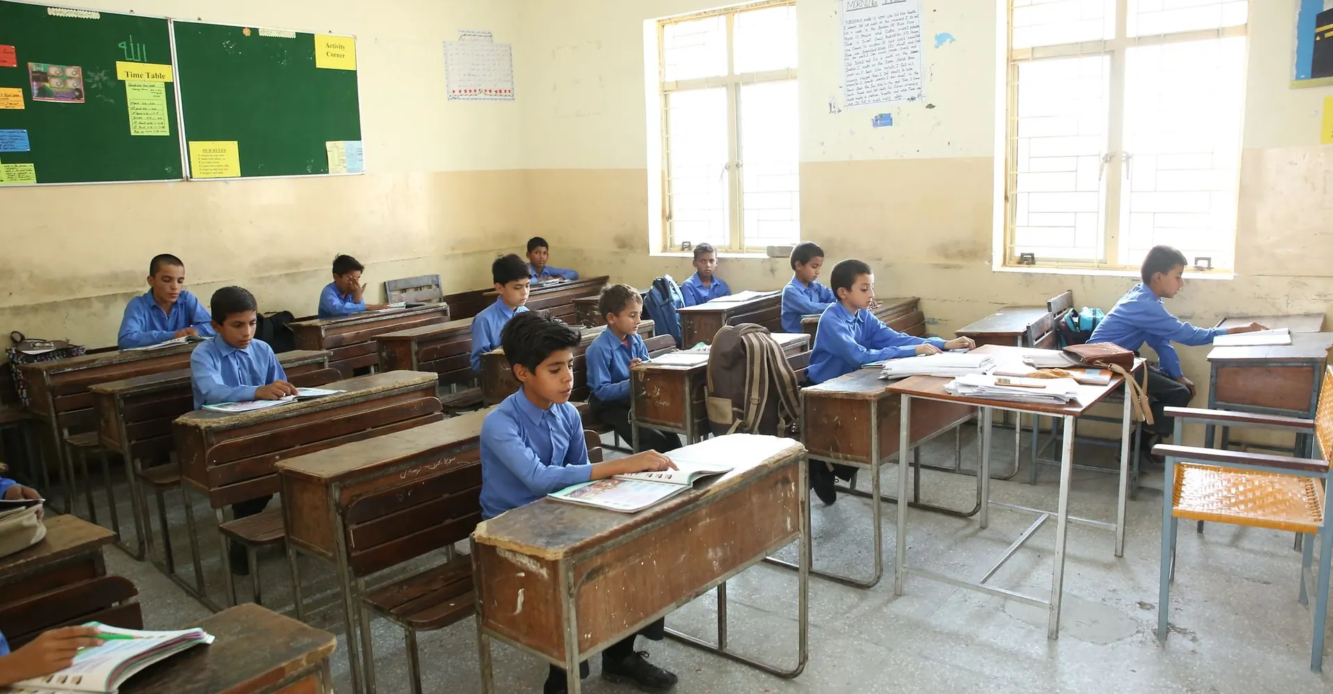 Pupils in school uniform working at their desks during a lesson